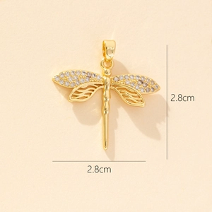 Detail view of gold dragonfly pendant with colorful zircons and 2.8cm size markings
