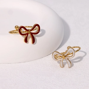Gold-plated bow tie stainless steel rings with enamel details in red and white colors