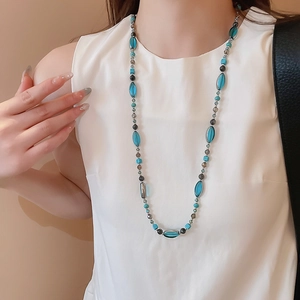Détail du collier de perles vintage avec pierres ovales bleu clair et perles grises