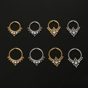 Detail of 316L stainless steel nose rings in gold and silver set with zircon stones