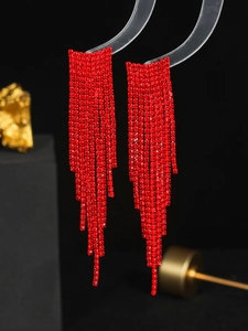 Detail of elegant red rhinestone long fringe earrings with a multi-layered cascading effect
