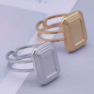 Macro view of geometric rectangle layered open rings in gold and silver steel finish