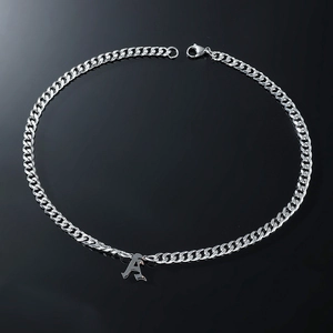 Detailed close-up of a silver gothic letter A pendant on a chunky cuban link chain