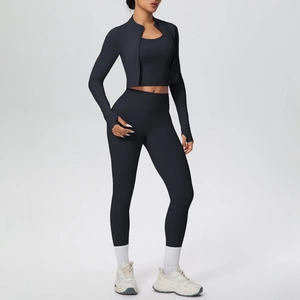 Detail of black three-piece yoga set with thumb holes on jacket and high waist pants
