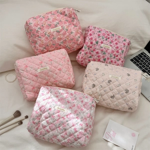 Detailed collection of pink quilted cotton makeup bags with various floral and animal patterns
