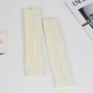 Detailed close-up of cream white cable knit fingerless gloves with texture