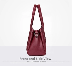 Detail view of burgundy tote bag side with woven handle and silver D-ring hardware