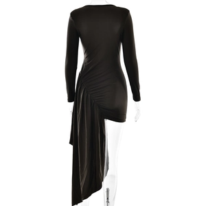 Detail of the elegant ruched side and asymmetric draped hem on the black mini dress