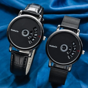 Detail view of two black minimalist watches with rotating disc dials on blue fabric