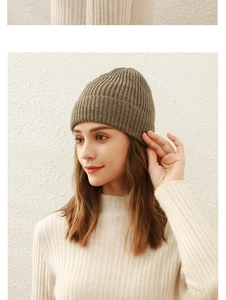 Close-up of the fine ribbed texture on a deep brown knitted beanie for winter warmth