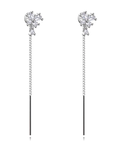 Detail showing elegant long tassel earrings with sparkling silver flower-shaped zircons
