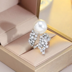 Macro detail of French style pearl ring with sparkling zircon in a velvet jewelry box