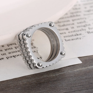 Macro shot of silver stainless steel square ring with decorative beads and wavy edges