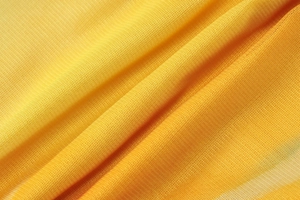 Macro texture de tissu tricoté jaune vif avec des plis souples et un tissage détaillé