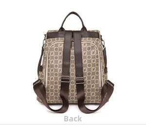 Detailed back view of vintage patterned backpack showing adjustable leather straps