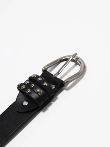 Detail of Y2K punk black leather belt with silver pin buckle and decorative metal rivets