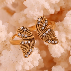 Detailed macro view of an 18K gold-plated butterfly ring with sparkling zircons