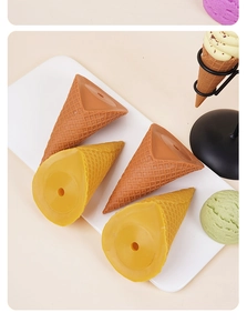 Detailed view of artificial ice cream cones with textured grid pattern and base holes