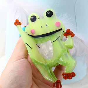Cute green translucent frog hair claw clip with rhinestones and orange limb details
