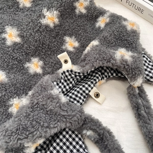 Detailed close-up of plush floral tote bag with checkered lining and metal snap button
