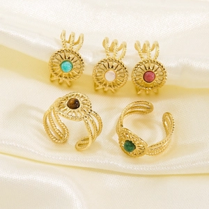 French vintage sunburst gold ring with gemstone inlays and braided adjustable band