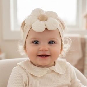 Close-up of baby nylon headband with 3D floral decoration and soft knit texture