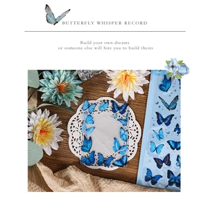 Close-up of blue butterfly PET stickers and transparent frame cards on dark wood table