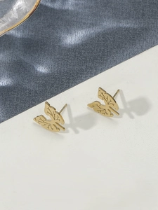Macro shot of gold lung-shaped earrings showing detailed leaf vein patterns and textures