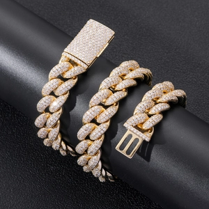 Macro shot of 20mm gold Cuban link chain with micro-pave zircons and secure box clasp