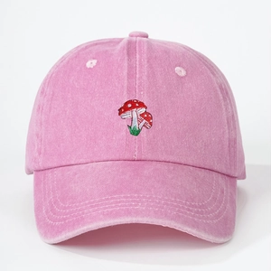 Pink washed cotton baseball cap with vintage mushroom embroidery in a front view