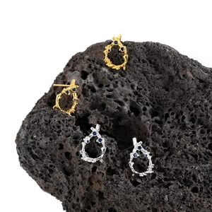 Irregular S925 silver lava earrings with blue stones on black volcanic rock