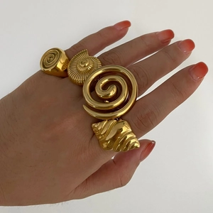 Golden stainless steel spiral and conch shell rings set for women in minimalist style