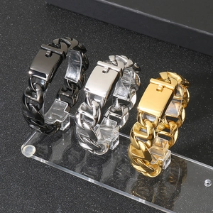 Detail of Cuban link chain bracelets in gold, silver and black with square buckles