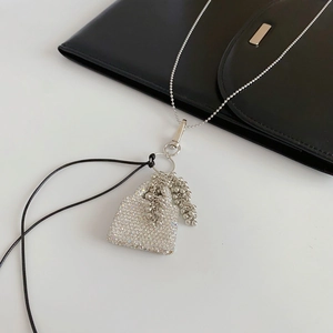 Détail du pendentif sac à main argenté avec strass brillants et chaîne à billes
