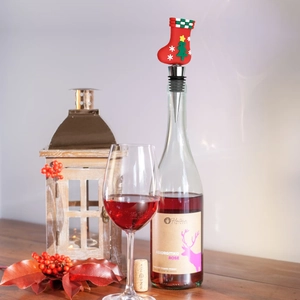 Detail of a red Christmas stocking wine stopper with tree motif in a rose wine bottle
