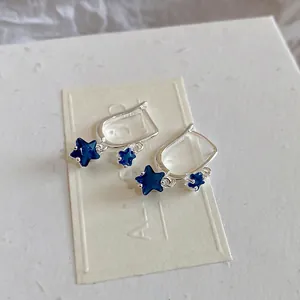 Polished S925 silver star earrings with deep blue zircon stones in a double-drop design