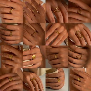 Multiple gold titanium steel rings in snake, heart, and geometric designs for women