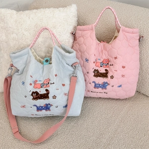 Close-up of quilted fabric texture and cute cartoon cat embroidery on crossbody bag