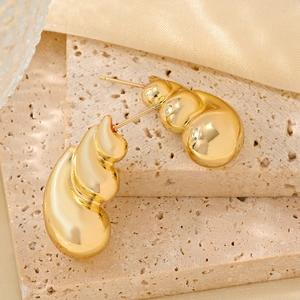 Elegant 14K gold plated shell-shaped spiral stud earrings on stone and silk background