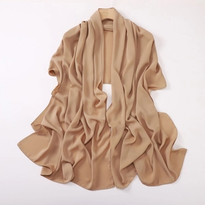 Detail of a beige satin scarf draped on a wooden hanger with a soft silk texture