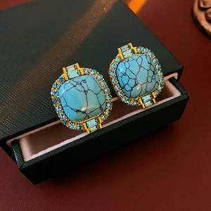 Detail of vintage square turquoise earrings with blue rhinestones in a luxury gift box