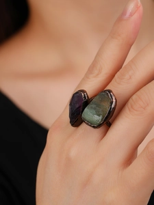 Close-up of vintage bronze open ring featuring raw purple amethyst and green fluorite stones
