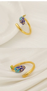 Detailed close-up of adjustable gold ring with colorful enamel flower bud and leaf accents