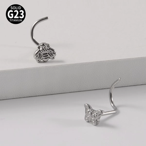 Pair of G23 titanium nose studs featuring butterfly and bee designs in silver finish