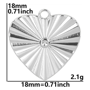 Macro view of 18mm silver heart pendant with sunburst texture and size markings