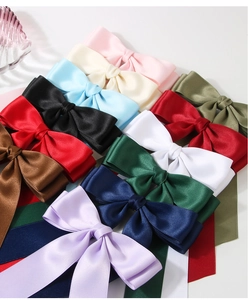 Top view of 12-piece double-layer satin bow hair clips in assorted vibrant colors
