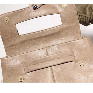 Khaki brown PU leather crossbody bag with spacious interior and magnetic snap closure