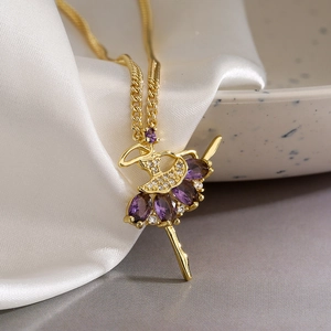 Detail of 18K gold ballerina pendant with purple marquise crystals on silk fabric