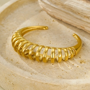 Detailed macro shot of the golden cutout stripes on the adjustable cuff bracelet