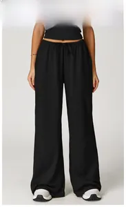 Detail of high-waisted black wide-leg joggers with elastic drawstring and draped texture